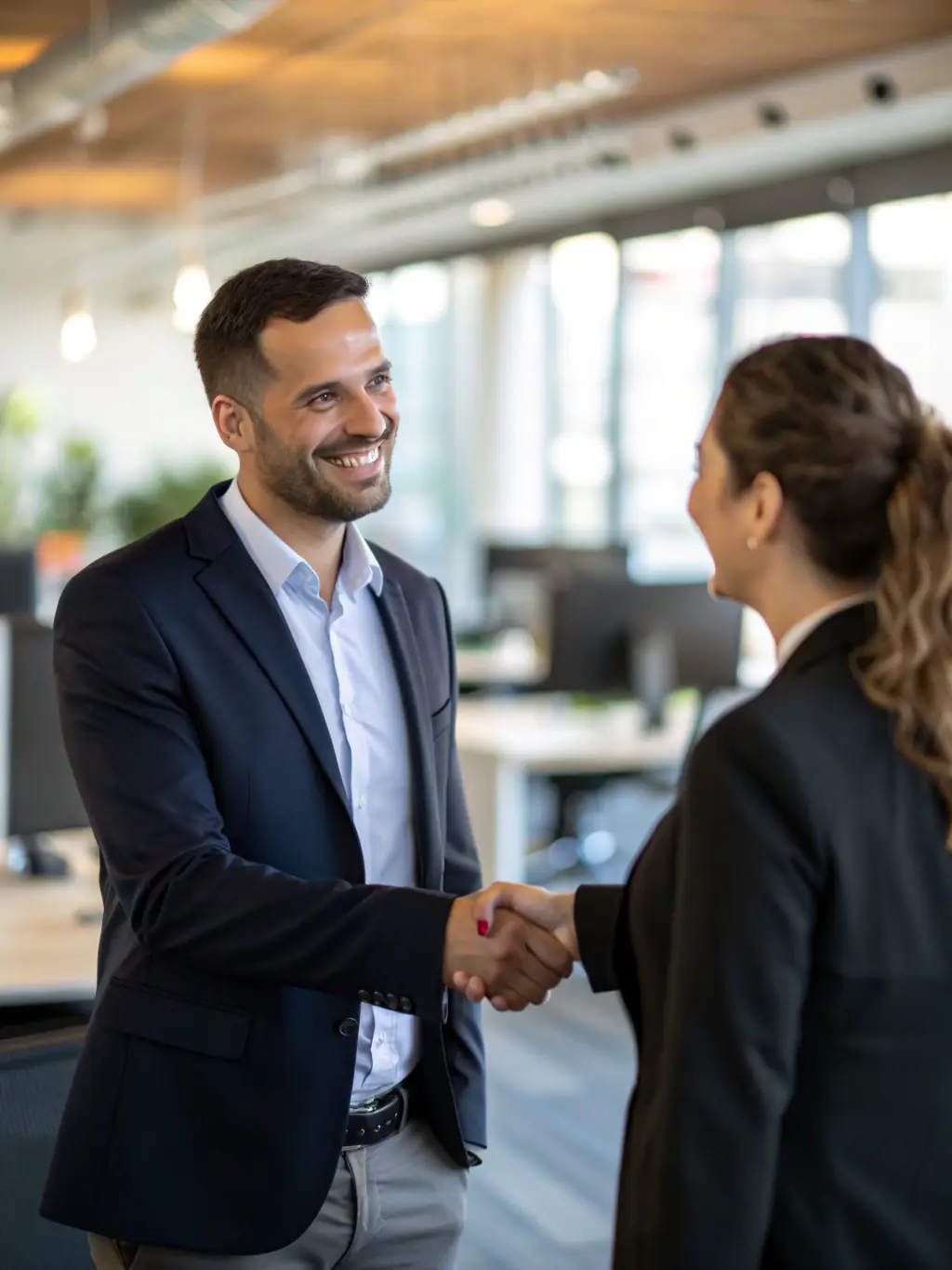 A person receiving funding, with a background of modern office and happy employees.